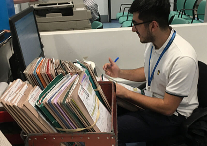 A person working in an office at a computer